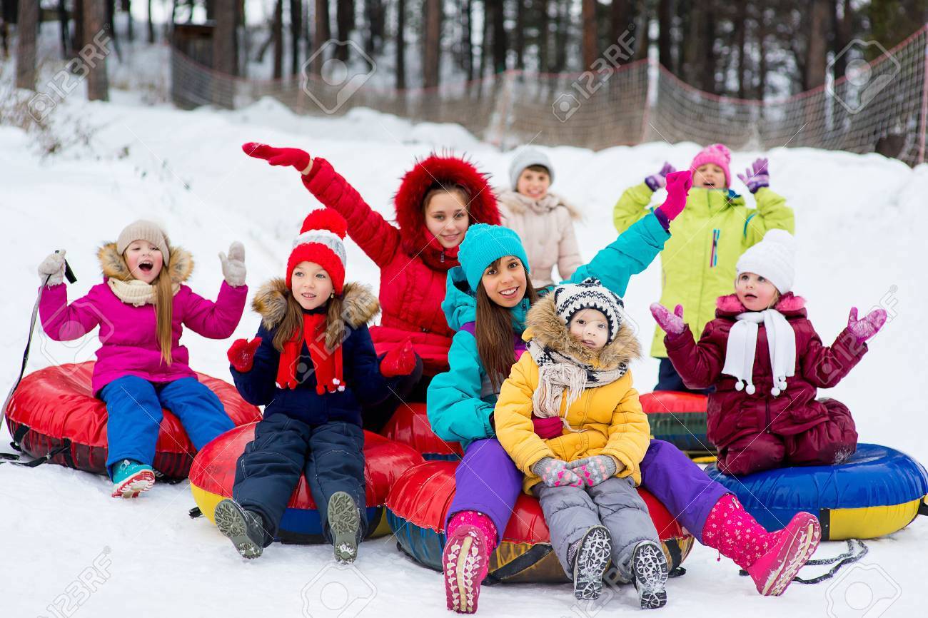 71573629-kids-on-snow-tubes-downhill-at-winter-day